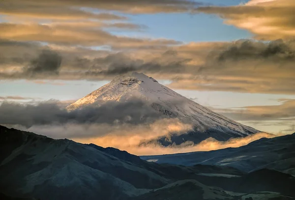 The north face of the Cotopaxi volcano at 6:30 A.M. with dramatic orange sunrise light view from the south of Quito, the capital of Ecuador