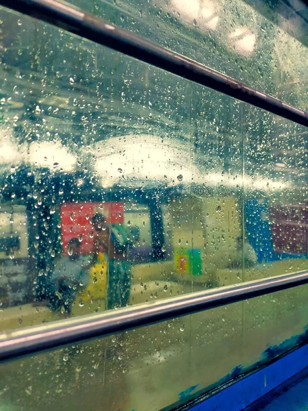 Drops of rain on the train window. Color tone texture background image.