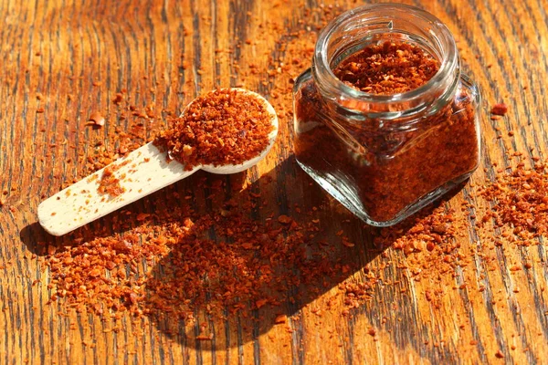 Red Chilli Flakes Wooden Table — Stock Photo, Image