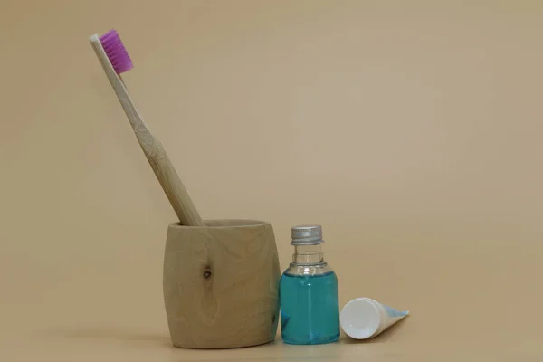 bathroom concept. Bamboo toothbrush, toothpaste, wooden toothbrush holder