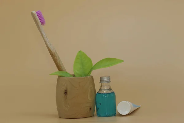 bathroom concept. Bamboo toothbrush, mouth rinse, toothpaste, toothbrush holder