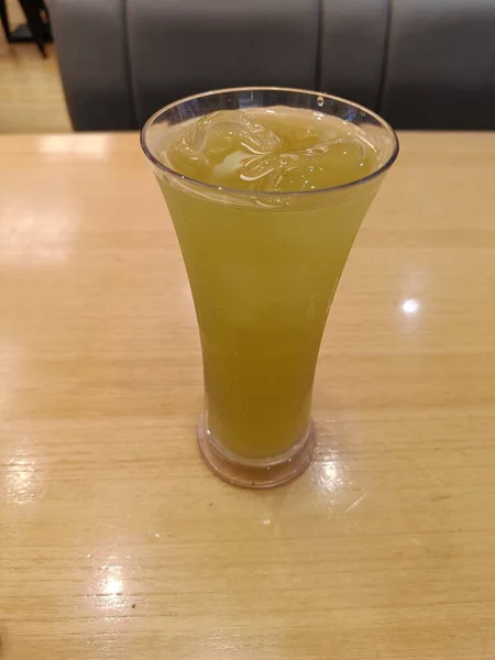 Green ocha tea drink with ice served in a restaurant