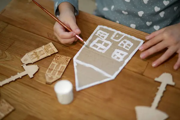 child making paper Christmas decoration, handmade toy, DIY