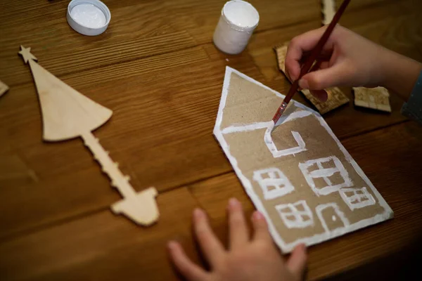 child making paper Christmas decoration, handmade toy, DIY