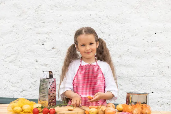 Şef Kostümlü Mutlu Küçük Kız Hamuru Yoğurarak Turta Pişirmeye Yardım Stok Fotoğraf