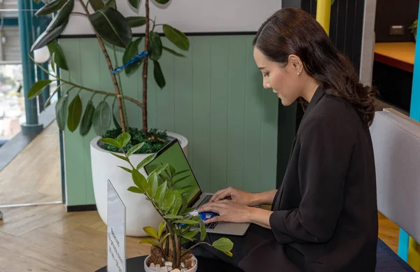 Young manager is using digital device for business plan on a table. Young owner applies digital tool and application for a startup business to save cost and make resource efficient