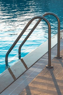 Otelde merdivenli ve ahşap güverteli yüzme havuzu. Yüksek kalite fotoğraf