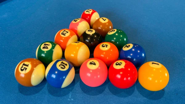 pool or billiards balls on light blue table