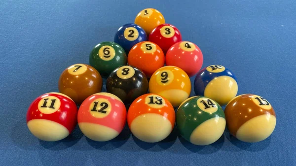 pool or billiards balls on light blue table
