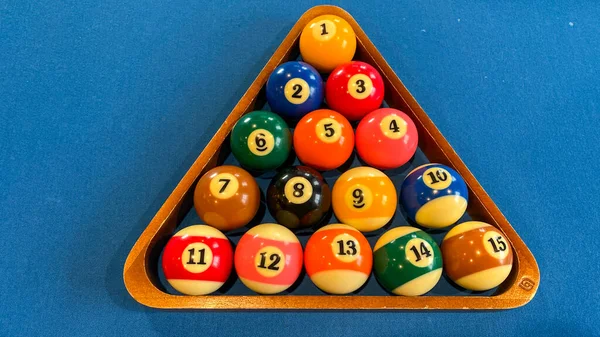 pool or billiards balls on light blue table