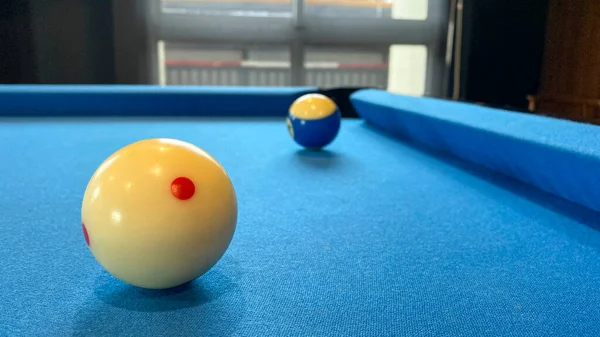 pool or billiards balls on light blue table