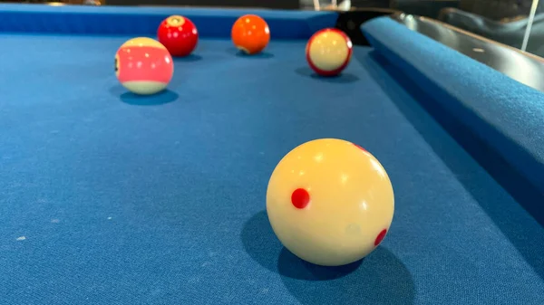 pool or billiards balls on light blue table
