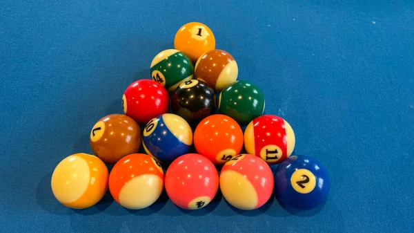 pool or billiards balls on light blue table