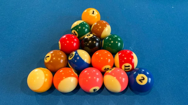 pool or billiards balls on light blue table