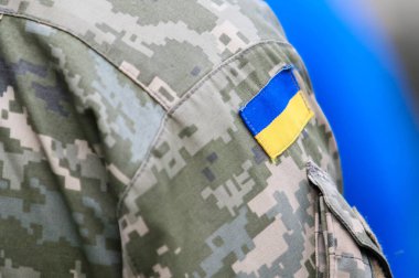 POLTAVA, UKRAINE - 19 Nisan 2022: Ukrayna Silahlı Kuvvetleri 'nin şehit askerlerinin defin töreni sırasında askeri üniformayla Ukrayna ordusunun logosu