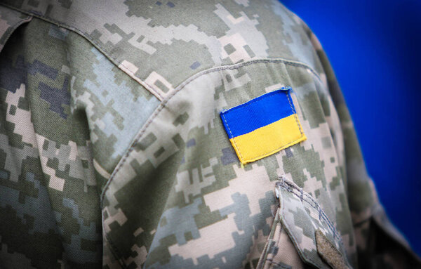 POLTAVA, UKRAINE - APRIL 19, 2022: Logo of the Ukrainian army in military uniform during the burial ceremony of fallen soldiers of the Armed Forces of Ukraine