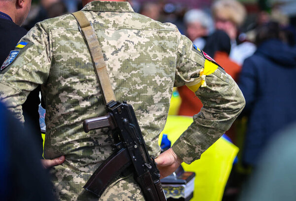 POLTAVA, UKRAINE - MAY 10, 2022: Fighter of the Territorial Defense of Ukraine during the funeral ceremony of soldiers