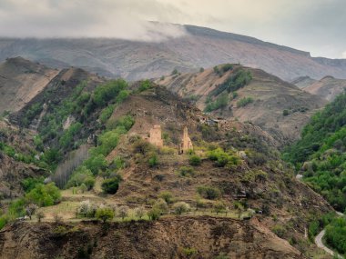 Stone ancient monastery on the green mountain. Memorial complex Vatan, Sogratl village in Dagestan. Russia.