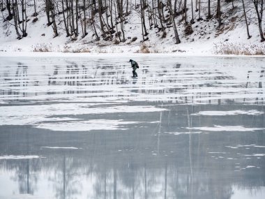 Dangerous exit to the spring thin ice. A man walks on thin ice. Forbidden access to the ice in the spring.