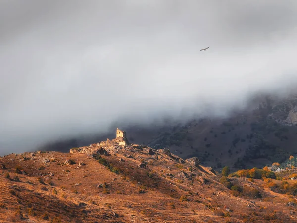 Beautiful dramatic landscape nature view in the mountains. Old Ossetian battle tower in the misty mountains. Digoria region. North Ossetia, Russia.