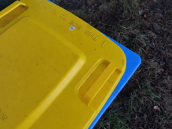 yellow plastic container  in garden
