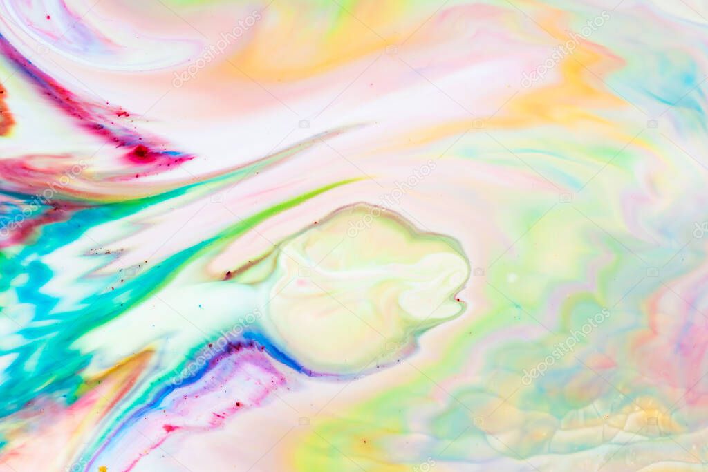 Multicolored lines and spots on liquid surface. Abstract background made with fluid art technique. Trendy colorful backdrop. Fluid art
