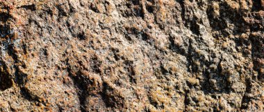 Granit kaya dokusu. Yıkılmış granit yüzeyi. Taş yüzeyine yakın çekim. Toprak rengi kavramı