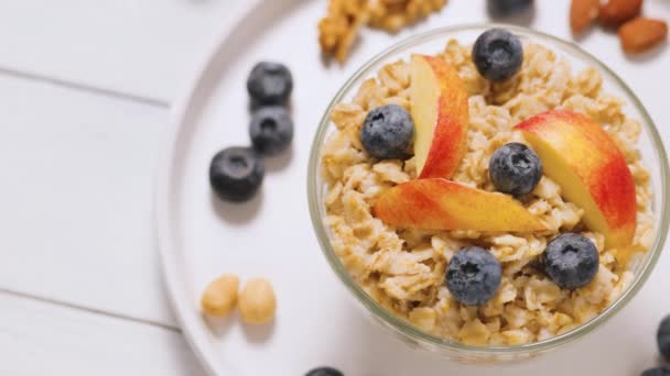 Oatmeal Blueberries Apple Slices White Plate Oatmeal Porridge Berries Nuts — Stock Video
