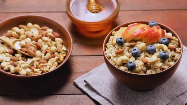 Oatmeal Blueberries Nuts Honey Wooden Background Oatmeal Porridge Apple Berries — Stock Video