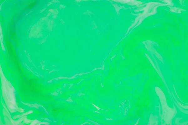 Green Fluid Art Background. Abstract liquid trendy backdrop. Different shades of green on a blurry surface