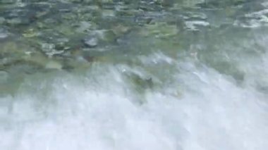 Waves on pebble beach. Clear water waves flowing over pebble beach shore