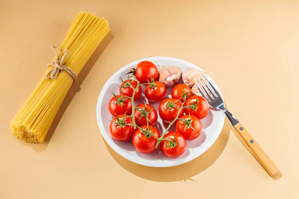 Spaghetti Pasta Con Pomodori Aglio Fondo Beige Pasta Cruda Verdure — Foto Stock
