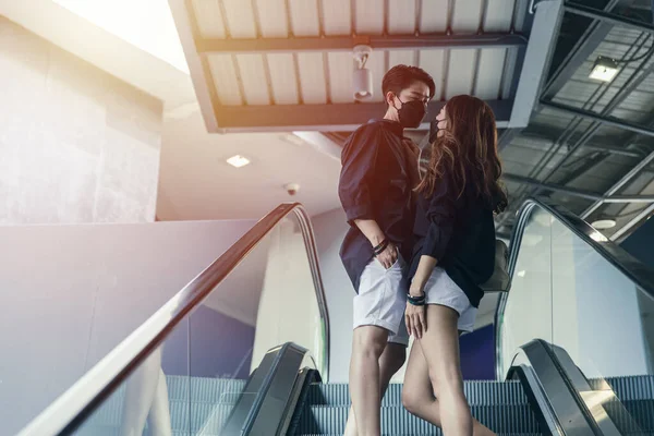 LGBT Asian women friend couple lover lifestyle happy together at shopping mall escalator