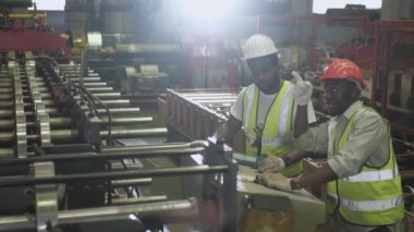 Siyah işçi, Mühendis Ekibi birlikte çalışıyor ve ağır bir fabrikada ustabaşı..