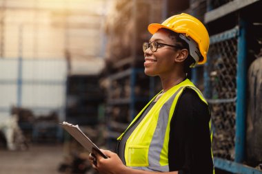 Happy Black African women engineer worker enjoy working in factory industry.