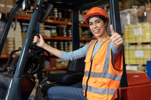 Happy woman worker warehouse staff forklift driver happy smiling enjoy working Asian people.