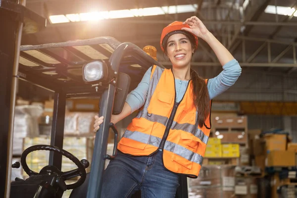 Happy woman worker warehouse staff forklift driver happy smiling enjoy working Asian people.
