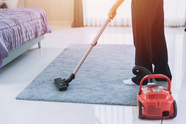 housewife cleaning dust the house Vacuum the carpet in the bedroom in the morning. maid using technology clean home housekeeping concept.