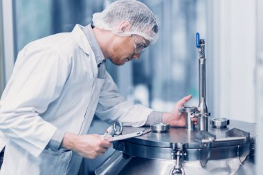 medicine science factory staff worker products sterilize process in autoclave tank in lab