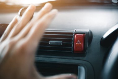 car air conditioner hand cover grill vent check temperature air flow cooling and fresh clean in summer season travel