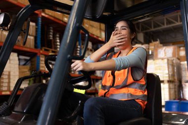 Insomnia Worker yawning feel sleepy while working in warehouse from hard work and sleepless