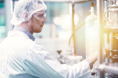 medicine factory scientist worker with Cannabis CBD oil extraction machine. Hemp oil extraction Thin Film Distillation Laboratory Plants Process.