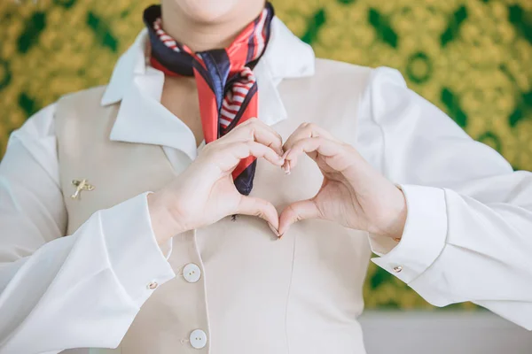 air hostess ground airline staff customer service with care mind heart sign gesture concept