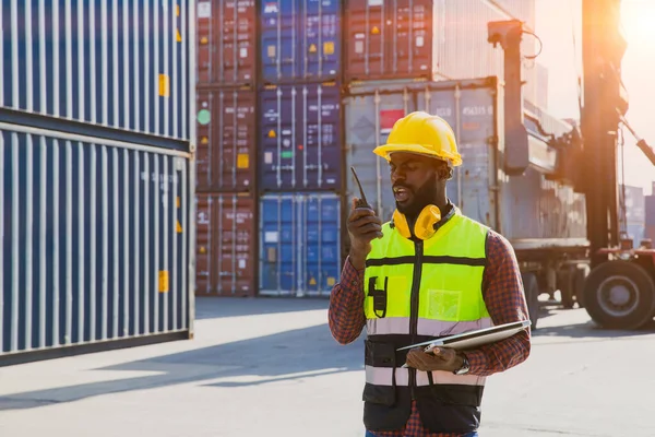 customs shipping staff worker working at cargo port container ship yard with radio control