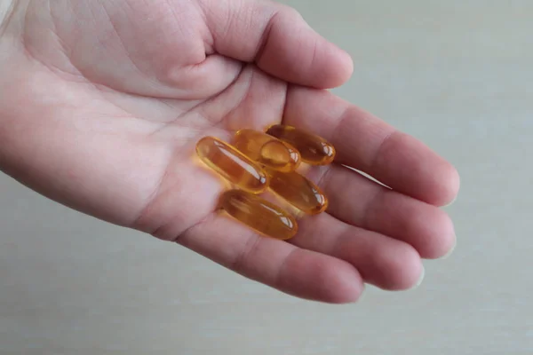 Woman Hand Vitamins Yellow Capsules — Stock Photo, Image