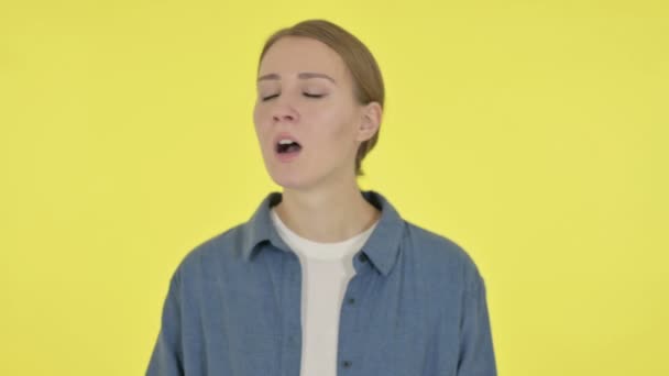 Young Woman Yawning on Yellow Background — Stock Video