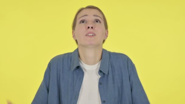 Disappointed Young Woman Reacting Loss on Yellow Background — Stock Video