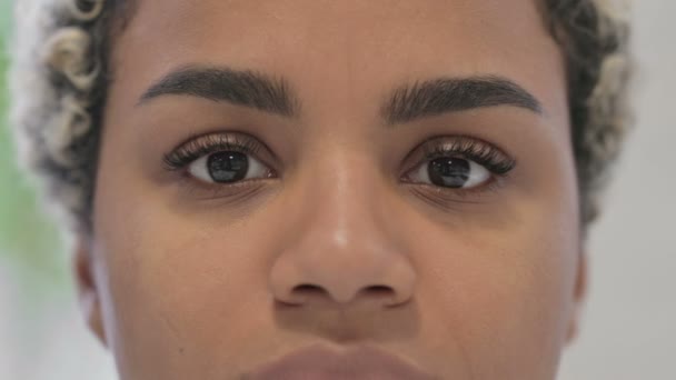 Blisko migające oczy afrykańskiej kobiety patrzącej w kamerę — Wideo stockowe