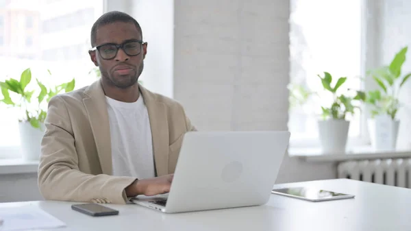 African Man Shaking Head as No Sign while using Laptop in Office — Stockfoto
