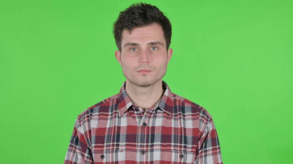 A Portrait of Serious Young Man Looking at the Camera, Green Chroma Screen — 스톡 사진